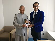 Yunus with Global health expert Dr Edmond at the UN University in Tokyo Noble Laureate Prof Muhammad Yunus receiving the book by Dr Edmond Fernandes.jpg
