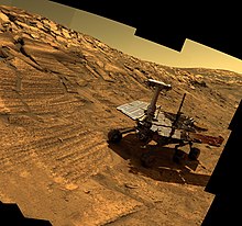 Artist generated view of Opportunity, in a real image taken by said rover of a crater Opportunity in Endurance Crater.jpg