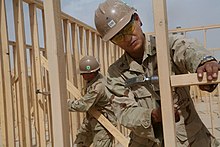 Camp Leatherneck, Afghanistan (13 May 2009) Navy Petty Officers 1st Class John Cid, from Quezon City, Philippines, and Thomas Damron, from Port Hueneme, California, frame walls of the Regimental Combat Team 3 Combat Operations Center at Camp Leatherneck.