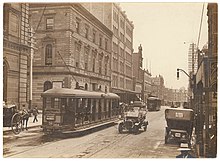 A tramcar on George Street in 1920. Sydney once had one of the largest tram networks in the British Empire. (Looking north along George Street (with tram, T-model Ford and hansom cab) from Union Line Building (incorporating the Bjelke-Petersen School of Physical culture), corner Jamieson Street), n.d. by (5955844045).jpg