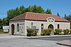 A small gray railroad station building