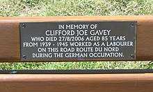 Plaque on bench "In memory of Clifford Joe Gavey who died 27/8/2006 aged 85 years from 1939-1945 worked as a labourer on this road Route du Nord during the German Occupation", Route du Nord, Saint John, Jersey Pliaque Clifford Joe Gavey Route du Nord Saint Jean Jerri a.jpg