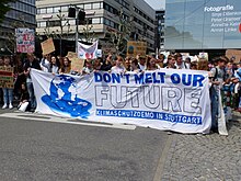 A color photograph of a group at a peaceful protest for climate change in Germany, taken in 2019.