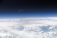 Atmospheric gases scatter blue light more than other wavelengths, giving the Earth a blue halo when seen from space.