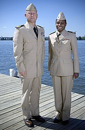Two naval officers showcase the now-discontinued service dress khaki uniform in September 2007. US Navy 070919-N-5319A-008 Two Sailors shows off the prototype uniform for service dress khaki, a throwback to the traditional WWII style uniform.jpg