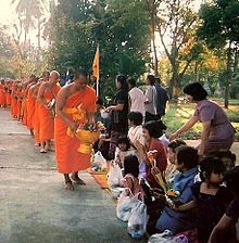 Buddhist monks on pindapata (alms round) receiving food from villagers Watkung 01.jpg