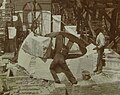 Workers setting rough stone in place, 1899.