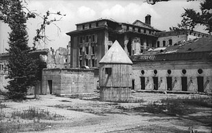 Exterior of the Fuhrerbunker
shortly before its destruction. Hitler and Braun's remains were burnt in a shell crater outside the emergency exit at the left. Bundesarchiv Bild 183-V04744, Berlin, Garten der zerstorte Reichskanzlei.jpg