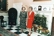 Thatcher and Nancy Regan stand together in a room containing antique furniture and flowers. A handwritten note at the bottom of the photograph reads "To Margaret—with respect and affection, Nancy."