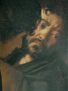 Visage d'un homme brun et barbu, qui regarde sur la droite, la tête penchée de côté et qui arbore une expression de tristesse.
