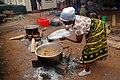 Image 43A Tanzanian woman cooks Pilau rice dish wearing traditional Kanga. (from Tanzania)