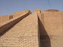 Very tall brick edifice under a blue sky.