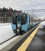 Electric train along a station platform