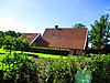 Boerderij Het Schurink, een geheel in baksteen gebouwd huis op een plint van Bentheimer zandsteen