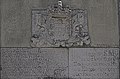 Stone-of-arms bearing an inscription.