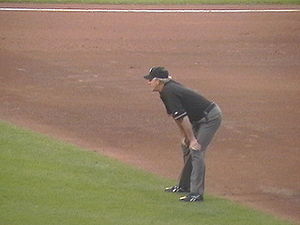 An umpire, the referee in baseball.
