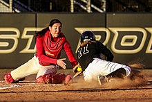 A baserunner attempting to slide into home plate is tagged out by the catcher. Marist Red Fox catcher Sarah Carmody (5), Army Black Knights outfielder Ali Cleinmark (11).jpg