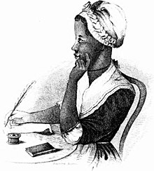 An 1864 portrait of Phillis Wheatley, an eighteenth-century African American. She sits at a table with a quill in her right hand, seemingly about to write on a sheet of paper on the table. Her left hand cups her chin and cheek, as if she is thinking.