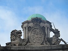 Royal arms of the United Kingdom of Great Britain and Ireland, still visible at King's Inns, Dublin. This version has the harp with a woman's head and breasts, as well as the arms of the House of Hanover at the centre, dating it to 1816-1837. Royal Arms of Ireland, King's inns.jpg