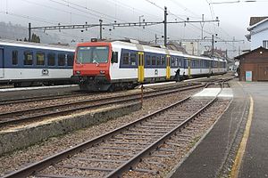 White train with red face in railway yard