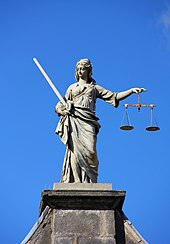 The balance scales seen in depictions of Lady Justice can be seen as representing the weighing of evidence in a legal proceeding. Dublin Castle Gates of Fortitude and Justice 05.JPG