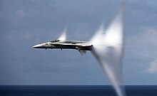 F/A-18C Hornet in transonic flight producing flow-induced vapor cone F-A-18C Hornet breaks the sound barrier.jpg