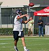 A football player in the middle of throwing a football