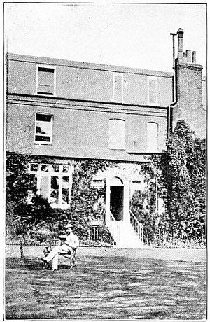 Charles Dickens reading in garden.