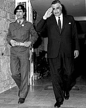Gaddafi (left) with Egyptian President Nasser in 1969. Nasser privately described Gaddafi as "a nice boy, but terribly naive". Nasser Gaddafi 1969.jpg