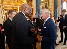 Governor-General Sir Rodney Williams speaking with King Charles III at Buckingham Palace, 2023 Realms Lunch Coronation Event (52872632535).jpg