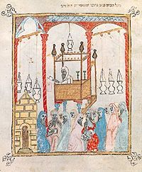 Image of a cantor reading the Passover story in Al-Andalus, from the 14th century Haggadah of Barcelona. Spanishhaggadah.jpg