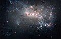 Image 1 NGC 4449 Photograph: NASA, ESA, A. Aloisi (STScI/ESA), and The Hubble Heritage (STScI/AURA)-ESA/Hubble Collaboration An image of NGC 4449, highlighting its qualities as a starburst galaxy. NGC 4449, an irregular galaxy in the constellation Canes Venatici located about 12 million light years from Earth, has a rate of star formation twice that of the Milky Way's satellite galaxy, the Large Magellanic Cloud. Interactions with nearby galaxies are thought to have influenced this star formation. More selected pictures