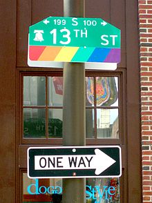 A street sign on the edge of Philadelphia's Gayborhood with a variation of the rainbow flag icon. 13th Gayborhood.jpg