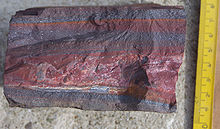 A banded iron formation from the 3.15 Ga Moodies Group, Barberton Greenstone Belt, South Africa. Red layers represent the times when oxygen was available; gray layers were formed in anoxic circumstances. Banded Iron Formation Barberton.jpg