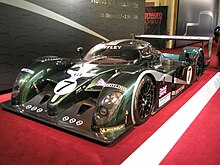 A LMP racing vehicle made by Bentley, sort of dark green.
