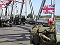 The bridge being crossed by military vehicles