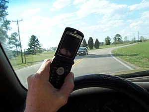 Person using cell phone while driving.