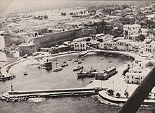 Aerial view of a town surrounding a harbour