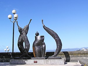 Photo of sculpture: female torso, apple and leaf-like shapes