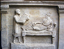 Slave holding writing tablets for his master (relief from a 4th-century sarcophagus) Sarcofago avvocato Valerius Petrnianus-optimized.jpg