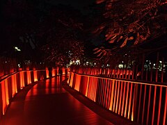 The park's Infinity Link bridge at night, illuminated in red