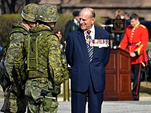 Prince Philip, Duke of Edinburgh, wearing at the neck the insignia of a Companion of the Order of Canada. Philip originally declined an honorary appointment to the Order of Canada, feeling the offer implied he was a foreigner to Canada. In April 2013, he accepted appointment as the first extraordinary Companion. The Duke of Edinburgh as Colonel-in-Chief of the Royal Canadian Regiment.jpg