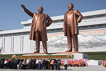 Citizens of North Korea bow to statues of former dictators Kim Il Sung and Kim Jong Il in 2012. The statues of Kim Il Sung and Kim Jong Il on Mansu Hill in Pyongyang (april 2012).jpg