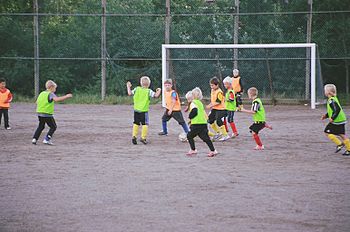 Kids playing football outside Turku