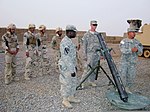 U.S. Soldiers, with Headquarters and Headquarters Company, 3rd Battalion, 8th Cavalry Regiment, 3rd Advise and Assist Brigade, 1st Cavalry Division, explain how to use an M120 120 mm mortar system to Iraqi 110704-A-PT121-003.jpg