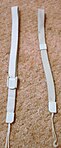 Wii Remote Strap versions. Newer on left, older on right.