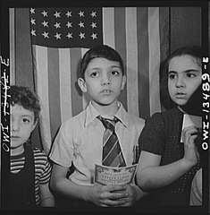 Children waiting in line to buy defense stamps at public school