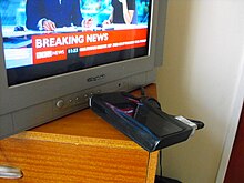 A modern Freeview receiver set-top box (Philips/Pace DTR 220) being used to receive digital television on an older analogue television set (branded Wharfedale) Digitalfreeview.jpg