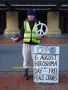 An anti-nuclear activist hands out peace cranes in Wellington Hiroshima Day Activist 2014.JPG