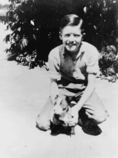 A monochrome picture of a young Jimmy Carter and his dog